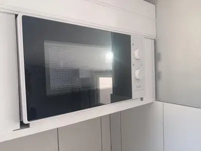 a microwave oven hanging on a wall at Good Knight Inn in Carcassonne