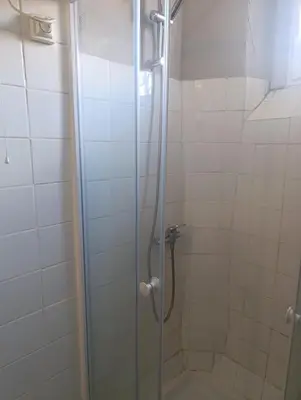 a bathroom with a shower with a glass door at Good Knight Inn in Carcassonne