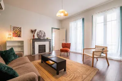 a living room with a couch and a fireplace at 203 Balcon de la Bastide in Carcassonne