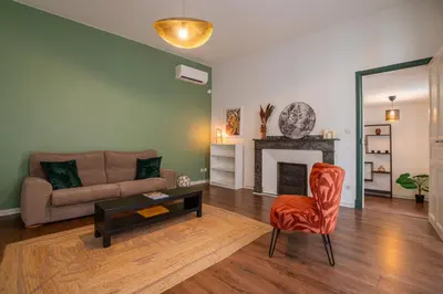 a living room with a couch and a chair at 203 Balcon de la Bastide in Carcassonne