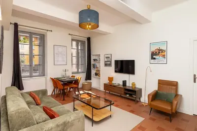 a living room with a couch and a table at T2 Design Centre Cité 10 min in Carcassonne