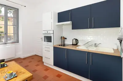 a kitchen with blue cabinets and a sink at T2 Design Centre Cité 10 min in Carcassonne