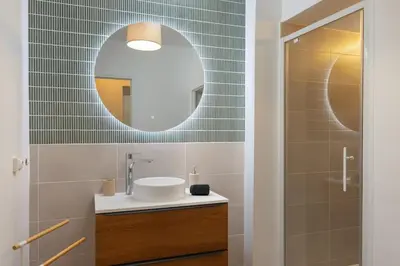 a bathroom with a sink and a mirror at T2 Design Centre Cité 10 min in Carcassonne
