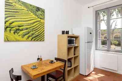 a dining room with a table and a refrigerator at T2 Design Centre Cité 10 min in Carcassonne