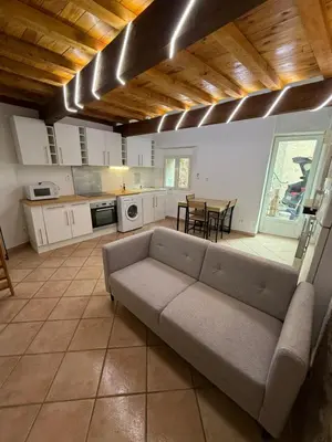 a large living room with a couch and a table at Petite maison in Castelnau-dʼAude