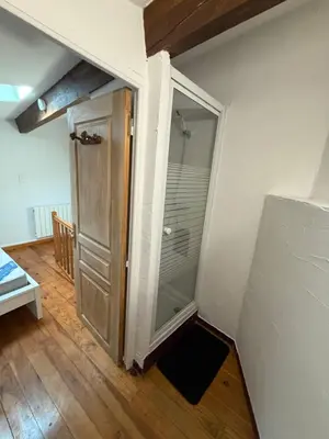 a glass door leading to a shower in a room at Petite maison in Castelnau-dʼAude