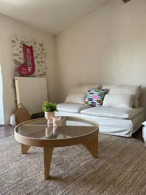 a living room with a couch and a coffee table at Suites zen dans maison d'hôtes avec piscine intérieure et jardin in Ventenac-Cabardès