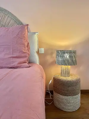 a bedroom with a bed with a lamp on a table at Suites zen dans maison d'hôtes avec piscine intérieure et jardin in Ventenac-Cabardès