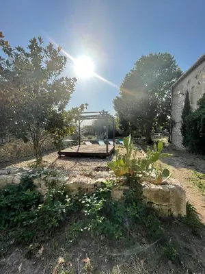a park with a playground with the sun in the sky at Suites zen dans maison d'hôtes avec piscine intérieure et jardin in Ventenac-Cabardès