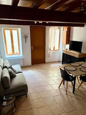 a living room with a couch and a table at Canalentin in Castelnaudary
