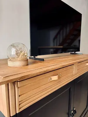 a flat screen tv on top of a wooden dresser at Canalentin in Castelnaudary