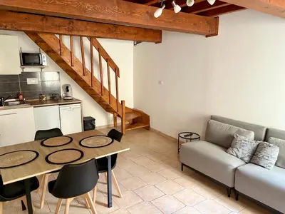 a living room with a table and a couch at Canalentin in Castelnaudary