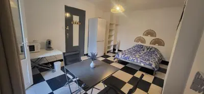 a bedroom with a bed and a table in a room at Chambre 1 - avec grande terrasse in Port-la-Nouvelle