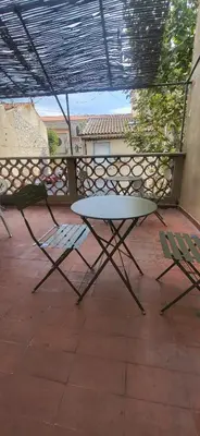 a table and two chairs on a patio at Chambre 1 - avec grande terrasse in Port-la-Nouvelle