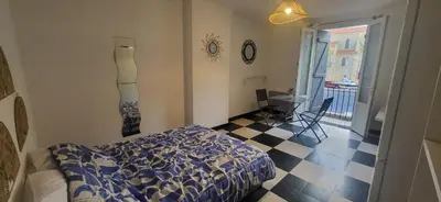 a bedroom with a bed and a checkered floor at Chambre 1 - avec grande terrasse in Port-la-Nouvelle