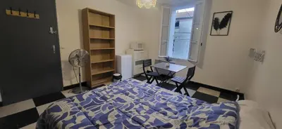 a bedroom with a bed and a desk and a window at Chambre 2 - avec grande terrasse in Port-la-Nouvelle