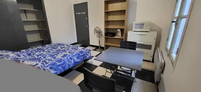 a bedroom with a bed and a table and a desk at Chambre 2 - avec grande terrasse in Port-la-Nouvelle