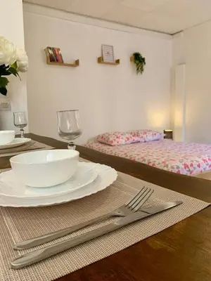 a table with a plate and a fork and knife at Studio Carcassonne Hyper Centre in Carcassonne