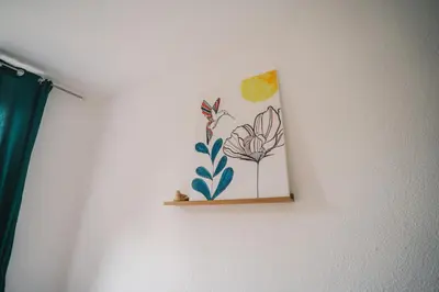 a picture of a flower on a wall at Charmant T2 au pied de la Cité de Carcassonne- AL in Carcassonne