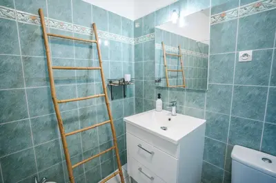 a bathroom with a sink and a toilet and a ladder at Charmant T2 au pied de la Cité de Carcassonne- AL in Carcassonne