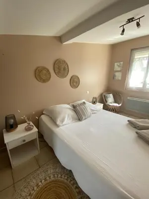 a bedroom with a large white bed and a window at Villa Bel Air in Puisserguier