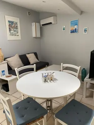 a living room with a white table and chairs at Villa Bel Air in Puisserguier