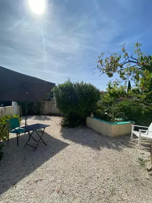 a patio with a table and an umbrella at Villa Bel Air in Puisserguier