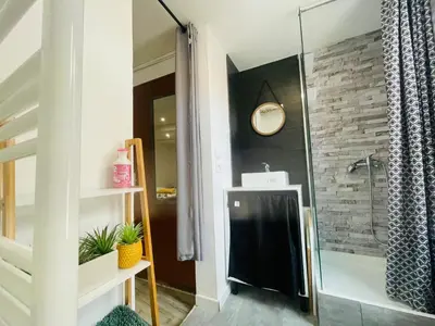 a bathroom with a shower with a black towel at Studette narbonaise in Narbonne