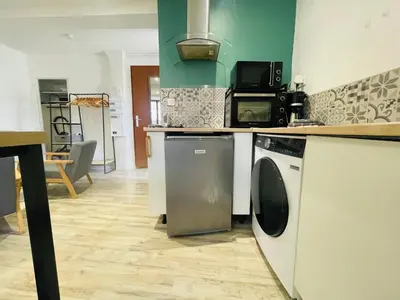 a kitchen with a washer and dryer in a room at Studette narbonaise in Narbonne
