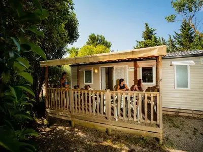 a group of people on the porch of a house at Mobil-home avec Terrasse à Lézignan-Corbières, 6 personnes - API-1-52-736 in Lézignan-Corbières