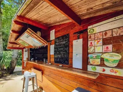 a restaurant with a bar with a chalkboard on the wall at Tente Toile & Bois - 2 Chambres, Terrasse - API-1-52-789 in Fenouillet