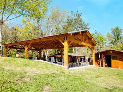 a pavilion with tables and chairs in a field at Tente Toile & Bois - 2 Chambres, Terrasse - API-1-52-789 in Fenouillet