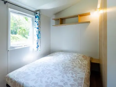 a small bedroom with a bed and a window at Tente Toile & Bois - 2 Chambres, Terrasse - API-1-52-789 in Fenouillet