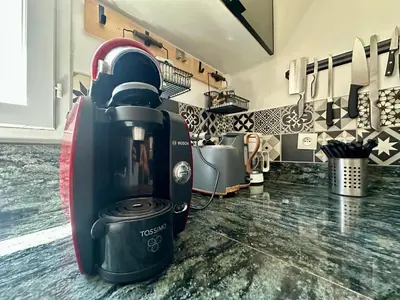 a kitchen with a coffee maker on a counter at Villa FURGY - Climatisation et parking in Carcassonne