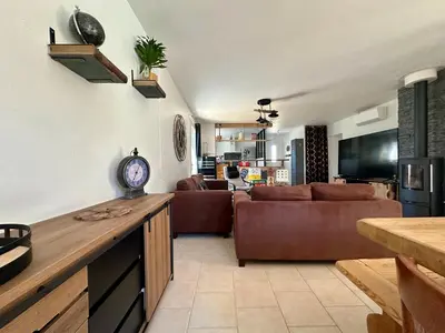 a living room with a couch and a table at Villa FURGY - Climatisation et parking in Carcassonne