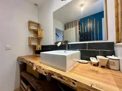 a bathroom with a white sink and a mirror at Villa FURGY - Climatisation et parking in Carcassonne