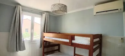 a bedroom with a bunk bed with a window at Villa Standing Piscine Chauffée in Gruissan