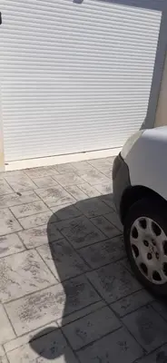 a shadow of a car parked in front of a garage at Chambre d'hôtes in Sigean