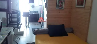 a small room with a yellow bed in a kitchen at Chambre d'hôtes in Sigean