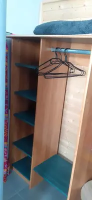 a bunk bed with blue shelves in a room at Chambre d'hôtes in Sigean