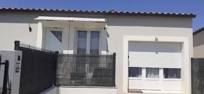 a white house with a gate and a fence at Chambre d'hôtes in Sigean