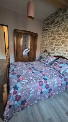 a bedroom with a bed with a colorful quilt at Charmant maison de village in Rieux-Minervois