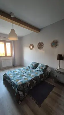 a bedroom with a bed in the corner of a room at Charmant maison de village in Rieux-Minervois
