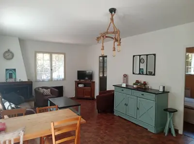a living room with a couch and a table at Les Yeuses in Brousses-et-Villaret