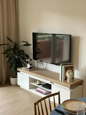 a flat screen tv on a white entertainment center at Apt T2 moderne & lumineux in Narbonne
