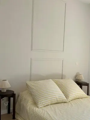 a bedroom with a bed with two end tables and two lamps at Apt T2 moderne & lumineux in Narbonne