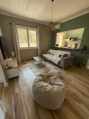 a living room with a bed and a bean bag chair at Appartement en centre-ville parking privé in Narbonne