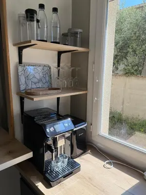 a coffee maker on a stand next to a window at Appartement en centre-ville parking privé in Narbonne