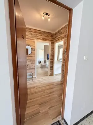a hallway in a house with a mirror at Appartement en centre-ville parking privé in Narbonne