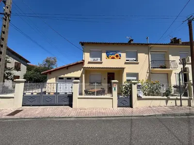 a house on a street with a fence at Aux Tournesols in Lavelanet